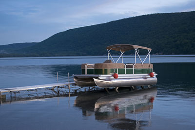 Boats moored in lake