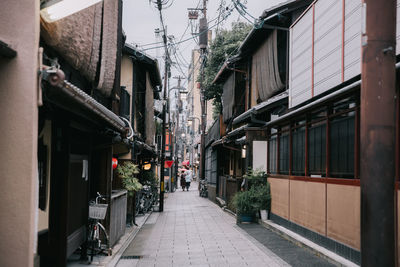 Narrow street amidst buildings in city