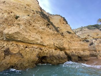 Rock formations in sea against sky