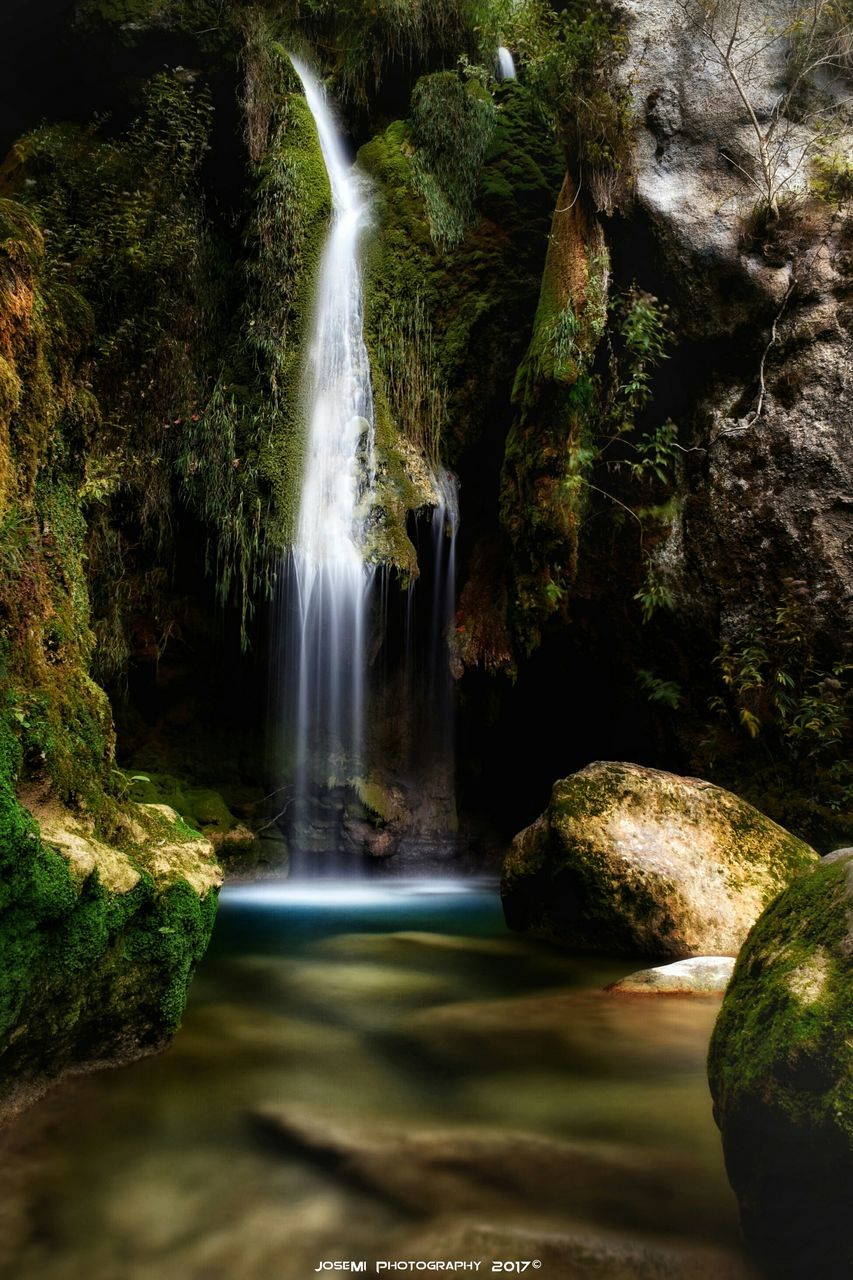 SCENIC VIEW OF WATERFALL IN FOREST