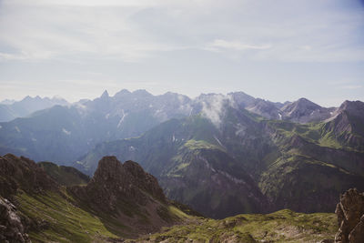 Scenic view of mountains against cloudy sky