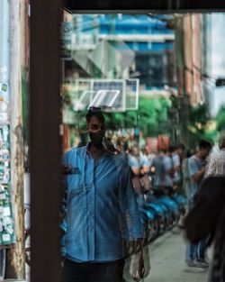 Portrait of man standing in city