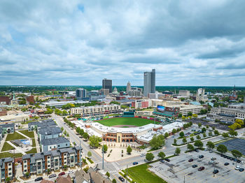 High angle view of cityscape against cloudy sky