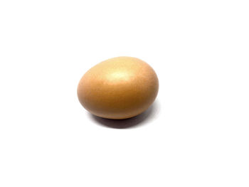 Close-up of eggs over white background