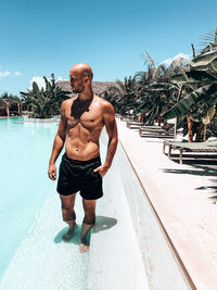 Full length of shirtless man in swimming pool