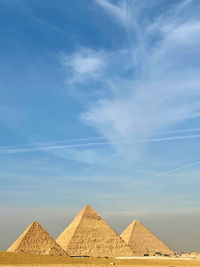 Scenic view of pyramids against sky