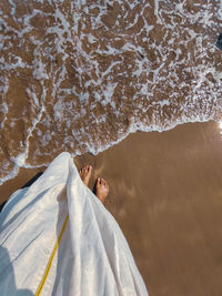 Portrait of woman lying on beach