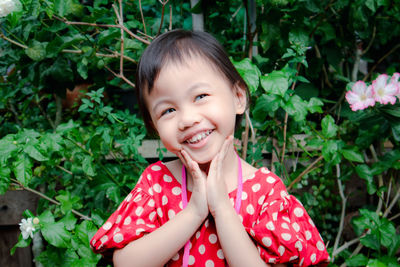 Portrait of smiling girl with plants