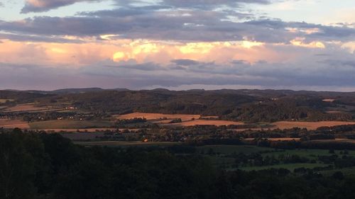 Scenic view of field against sky at sunset