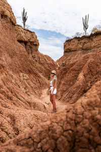 Rear view of woman standing on rock