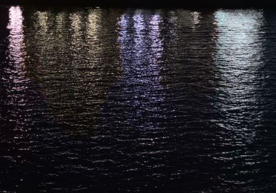 Reflection of purple water in dark