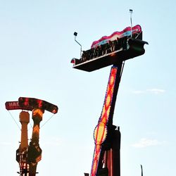 Low angle view of amusement park ride against sky