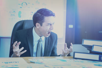 Angry businessman screaming in office