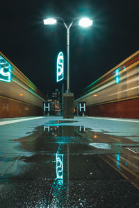 Illuminated light trails on road in city at night