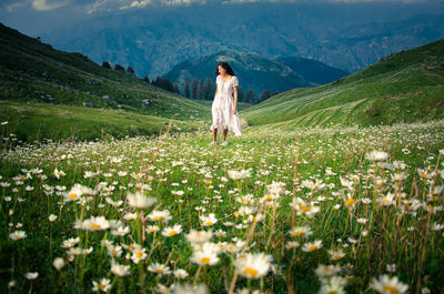 Full length of woman standing on field