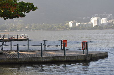 Scenic view of river by city against sky