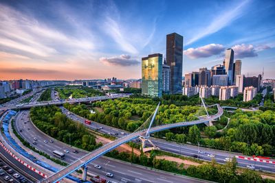 Panoramic view of city street and buildings against sky