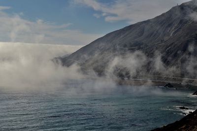 Scenic view of sea in foggy weather against sky