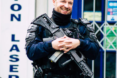 Man holding camera while standing outdoors