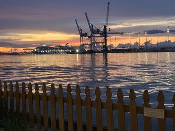 Silhouette pier by sea against sky during sunset