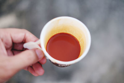 Midsection of person holding tea cup