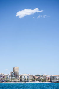 View of cityscape against blue sky