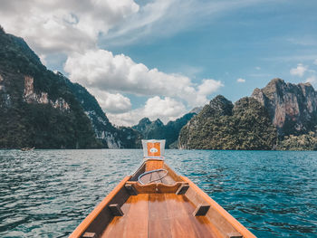 Scenic view of sea and mountains against sky