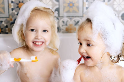 Cute girls bathing in bathtub