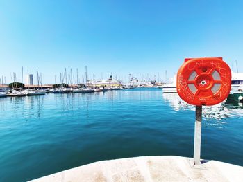 Sailboat on sea against clear blue sky