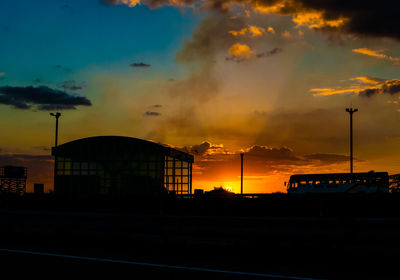 Silhouette buildings against sky during sunset