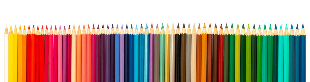 Close-up of colored pencils against white background