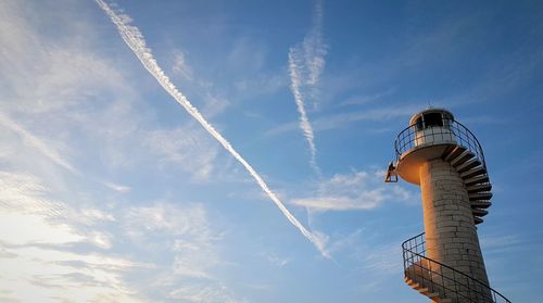 Low angle view of vapor trails against sky