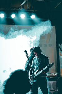 Man playing guitar at music concert