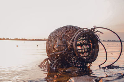 Traditional rattan woven fishing creel basket left behind in the rising tide 