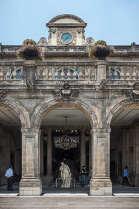 Tourists at entrance of historic building