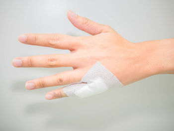 Close-up of human hand over white background