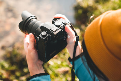 Cropped hand of man photographing with camera