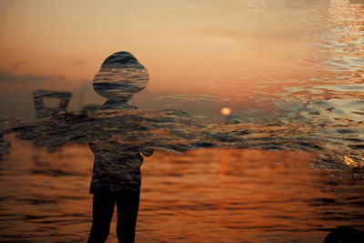 Reflection of man standing in water