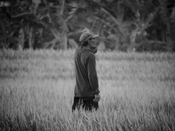 Side view of man standing on field