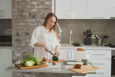 Woman eating food at home