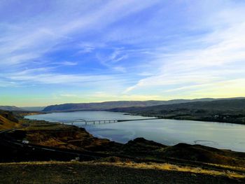 Scenic view of river against cloudy sky