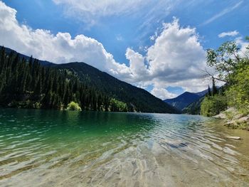 Scenic view of lake and mountains against sky