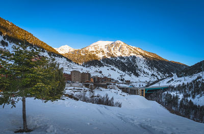 Soldeu village with mountain range illuminated by sunset in the background, andorra