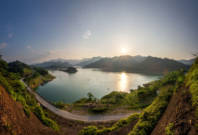 Scenic view of lake and mountains against sky