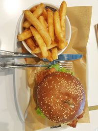 Close-up of burger and fries in plate