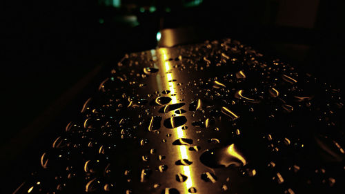 Close-up of illuminated lighting equipment against black background