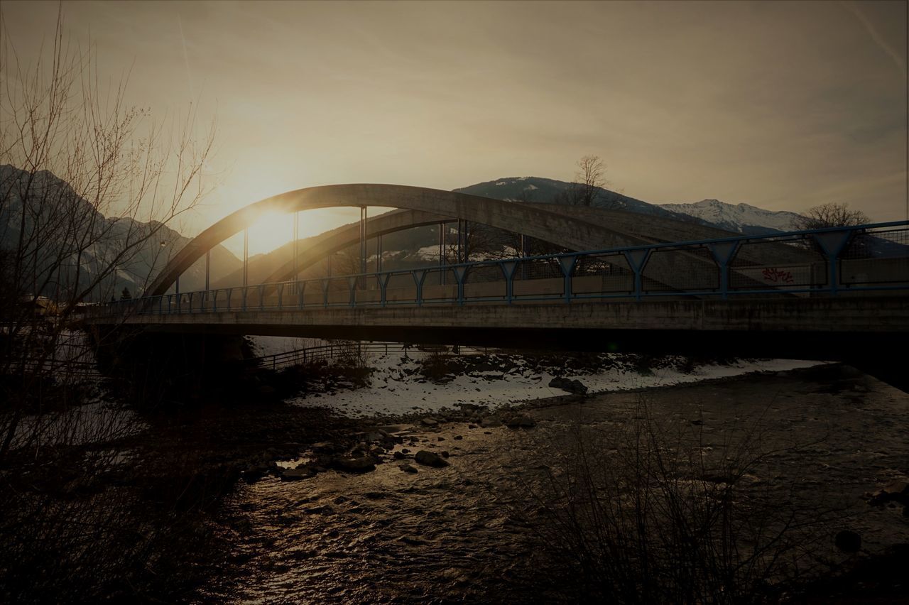 VIEW OF BRIDGE OVER RIVER AGAINST SKY DURING SUNSET