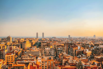 High angle view of buildings in city against sky during sunset