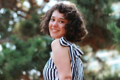 Portrait of smiling woman standing outdoors