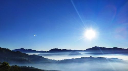 Scenic view of mountains against blue sky